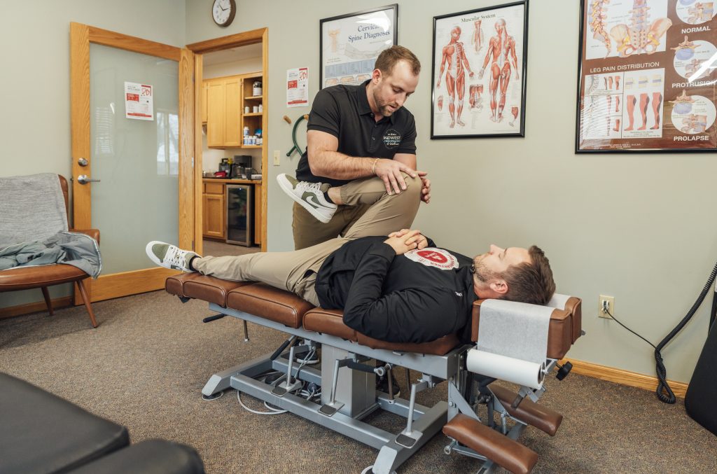 Dr. Zach giving a chiropractic adjustment at Midwest Chiropractic & Wellness