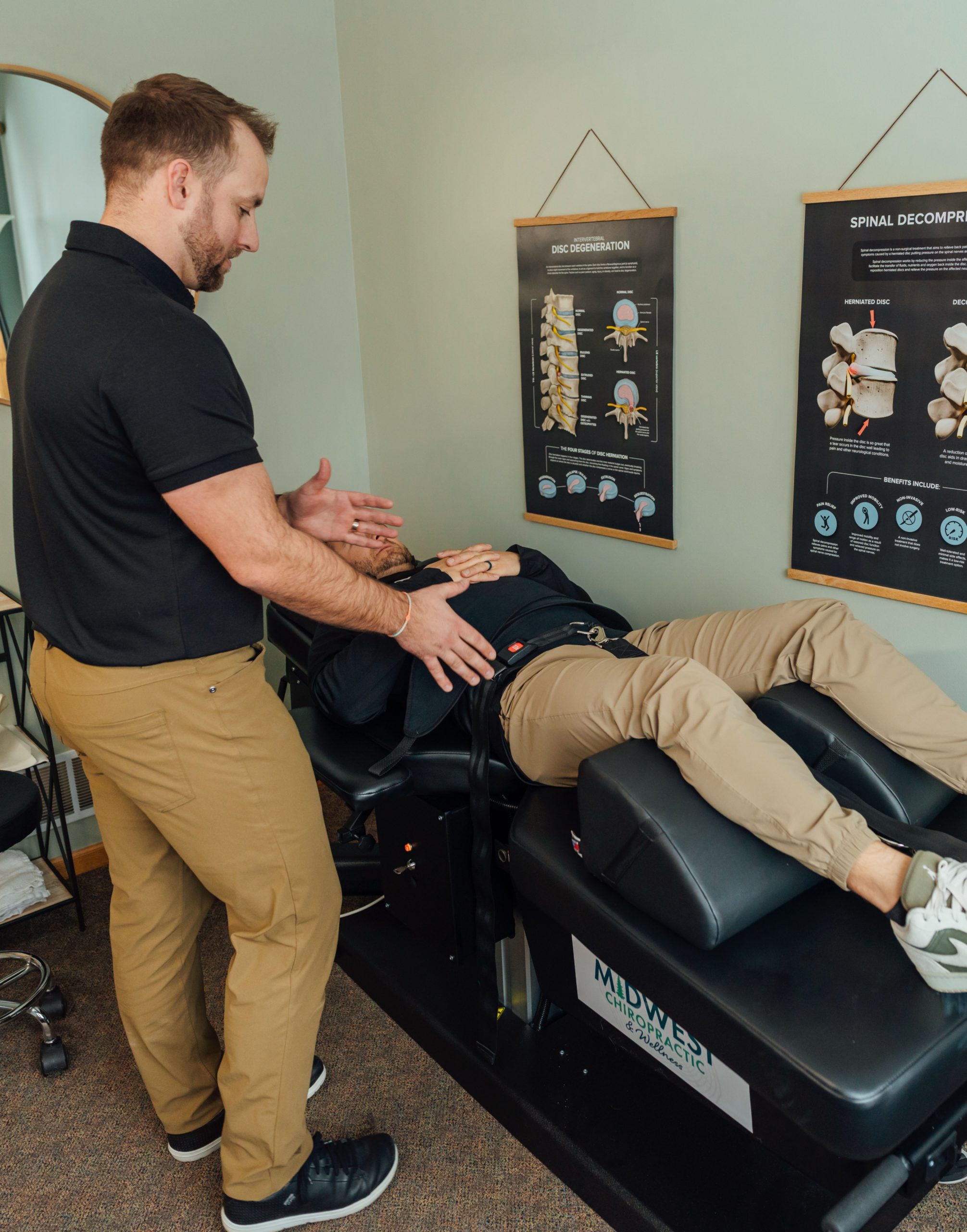 Dr. Zach helping position a patient on the spinal decompression table.